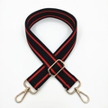 Detail of adjustable wide striped shoulder strap with gold metal hooks and buckle - Black Red Stripe