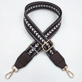 Detail showing embroidered chevron nylon shoulder strap with brown leather and gold hardware - Coffee