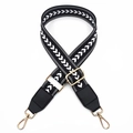 Detail view of nylon bag strap with white arrow embroidery and gold metal lobster clasps - Black