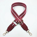 Detail of adjustable dark red nylon bag strap with white arrow embroidery and gold hooks - Burgundy