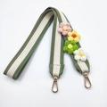 Close-up of thick woven floral shoulder strap with green stripes and gold metal hooks - Bean Green Long Style