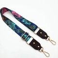 Close-up of adjustable strap with floral patterns, leather ends and gold metal hooks - Blue Flowers + Black