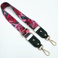 Detail of adjustable floral shoulder strap with pink base, gold rivets and metal hooks - Red Flowers + Black
