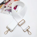 Detail of white wide woven adjustable shoulder strap with gold metal buckles and waffle texture - Pure White