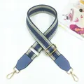 Macro detail of adjustable grey blue woven bag strap with golden metal hook and leather trim - Lake Blue
