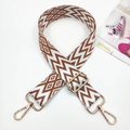Detail of adjustable geometric woven strap with gold metal hooks for crossbody bags - White Base Brown