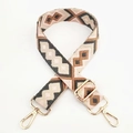 Close-up of geometric jacquard embroidered bag strap with gold metal lobster clasps - Pink Khaki Grey