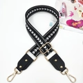 Close-up of geometric jacquard bag strap with gold lobster clasps and metal rivet details - White Arrow Pattern