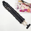 Detail of black canvas phone strap with fringe trim and golden metal lobster clasps - Gold Buckle / Black With Gasket