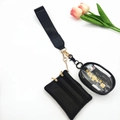 Detail view of mini wristlet set with black leather pouch and clear PVC storage bag - Pure Black