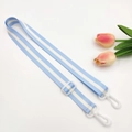 Detail view of adjustable blue and white striped strap with white plastic swivel hooks - Light Blue + White Buckle