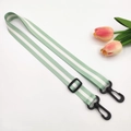 Close-up of mint green striped nylon strap with black plastic swivel hooks and adjuster - Green with Black Hook