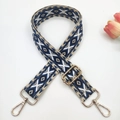 Detail of bohemian geometric woven bag strap with gold lobster clasps and diamond pattern - Gold Buckle / Blue and White on Beige