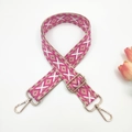 Close-up of pink geometric ethnic style woven bag strap with golden metal lobster clasps - Rose Pink With Beige Base
