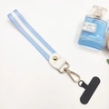 Detail view of a light blue striped fabric wrist lanyard with a gold-tone metal hook clasp - Short Light Blue (With Phone Patch)