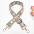 Close-up of geometric embroidered bag strap with golden metal swivel hooks and buckles - Beige Base Light Khaki