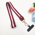 Close-up of red and white striped polyester wrist strap with gold metal clasp and phone pad - Long Wine Red (With Phone Patch)