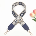 Close-up of ethnic embroidered bag strap with golden metal hooks and navy leather ends - Gold Buckle / Beige Navy Blue