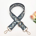 Close-up of ethnic jacquard embroidered strap with golden metal lobster clasps - Black base Light Blue