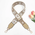 Close-up of adjustable ethnic wide strap with floral jacquard and gold metal hooks - Gold Buckle / Beige Base Khaki
