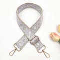Detail of adjustable wide shoulder strap with purple geometric pattern and gold hardware - Gold Buckle / Beige Base Light Purple