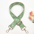 Detail of adjustable geometric weave bag strap with golden lobster clasps and buckles - Beige Green