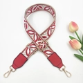 Close-up of ethnic style wide embroidery purse strap with floral pattern and gold hooks - Red on Beige