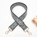 Close-up of bohemian geometric woven purse strap with gold swivel lobster clasps - Black base Light Blue