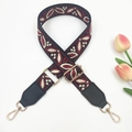 Close-up of ethnic style woven bag strap with black leather ends and gold metal hooks - Wine Red on Black