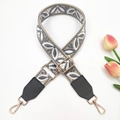 Detail of grey and white embroidered bag strap with gold metal hardware on white background - Dark Grey on Beige