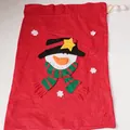 Detail of red Christmas drawstring gift bag with snowman applique and white pompoms - Large Snowman Style
