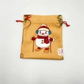 Detail view of snowman pattern on festive orange Christmas drawstring gift bag - Yellow Sleigh Snowman