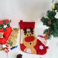Close-up of a festive non-woven Christmas stocking with reindeer applique and snow decor - Reindeer Style