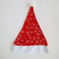 Close-up of red Christmas hat featuring white snowflake patterns and soft plush trim - Red Non-woven Snowflake Style