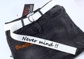 Detailed view of white canvas belt with black slogan and metal D-ring buckle - White