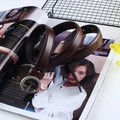 Detailed view of deep brown PU leather belt with silver round buckle on a magazine background - Round Buckle (Coffee)