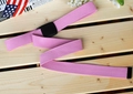 Detailed close-up of a pink nylon canvas belt with a black plastic buckle on wood - 120cm / Pink