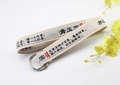Detail view of cream canvas belt with black Chinese poem print and silver double D-ring buckle - Apricot
