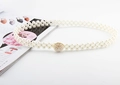 Detail of elegant double-row pearl waist chain with large circular pearl encrusted buckle - Round Pearl Gold Buckle Pearl Belt