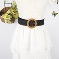 Women's black woven waist belt with a round wooden buckle on a white pleated dress - Black Faux Woven Round Buckle