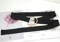 Detail of minimalist black fabric belt with golden double ring buckle on a fashion magazine - Black