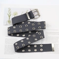 Macro shot of dark grey canvas belt with star-shaped metal eyelets and silver buckle - Gray