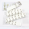 Detailed macro view of white canvas belt with star-shaped eyelets and double-prong buckle - White
