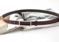 Close-up of minimalist burgundy leather thin belt with rectangular silver buckle on a magazine - Burgundy / 105cm