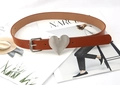 Detail of a dark brown leather belt with a large silver heart-shaped buckle on a magazine - Khaki