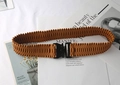 Detailed close-up of brown pleated elastic waist belt with black buckle on white background - Camel