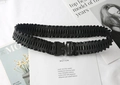 Detail of black pleated elastic waist belt with textured metal tactical buckle closure - Black