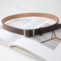 Close-up of minimalist dark brown leather belt with silver buckle on magazine - Pearl Silver Buckle (Black)