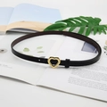 Women's black faux leather belt featuring a polished golden heart-shaped metal buckle - Black