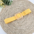 Yellow woven elastic waist belt with a transparent resin square buckle on straw mat - Yellow